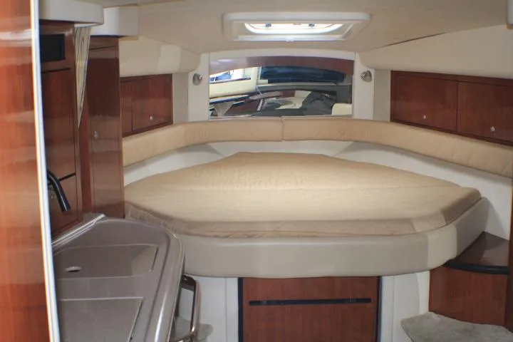 Slide: The Image of Interior cabin of 2007 Sea Ray 340 Sundancer with cozy bed and wooden cabinetry. - 47