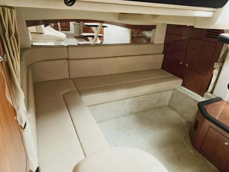 Slide: The Image of Interior of 2007 Sea Ray 340 Sundancer with beige seating and wooden cabinetry. - 49