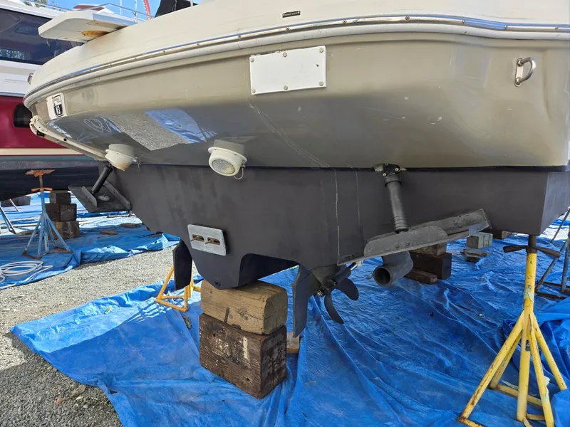 Slide: The Image of 2007 Sea Ray 340 Sundancer boat on stands, hull view, blue tarp underneath. - 7
