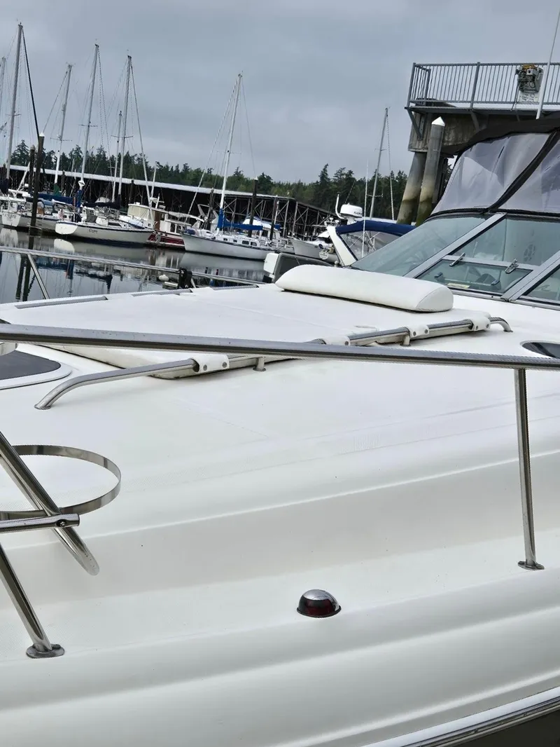 Slide: The Image of 2007 Sea Ray 340 Sundancer yacht docked at a marina with sailboats in the background. - 9