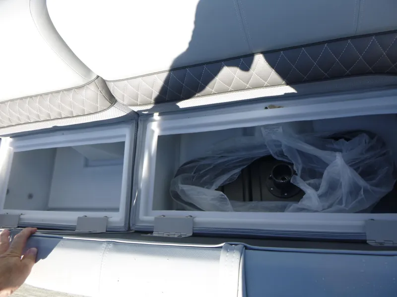 Slide: The Image of 2024 Ranger Reata 223C storage compartments with cushioned seating and protective covers. - 10