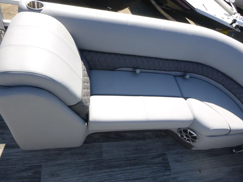 Slide: The Image of 2024 Ranger Reata 223C boat interior with gray cushioned seating and speaker. - 11