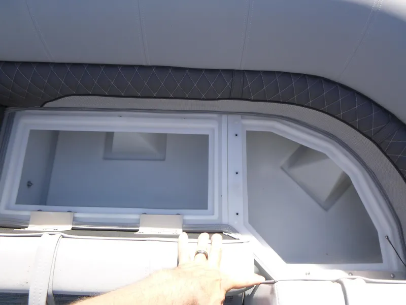 Slide: The Image of 2024 Ranger Reata 223C boat storage compartment with cushioned seating. - 12