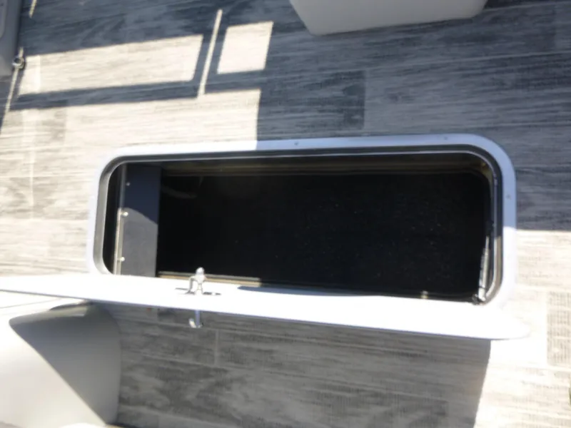Slide: The Image of 2024 Ranger Reata 223C boat storage compartment with open hatch on deck. - 14