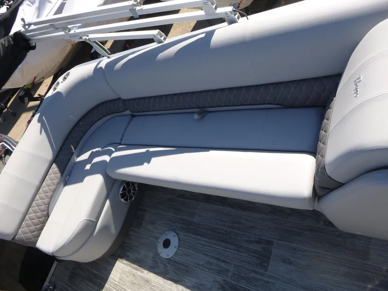 Slide: The Image of 2024 Ranger Reata 223C boat interior with gray cushioned seating and modern design. - 15