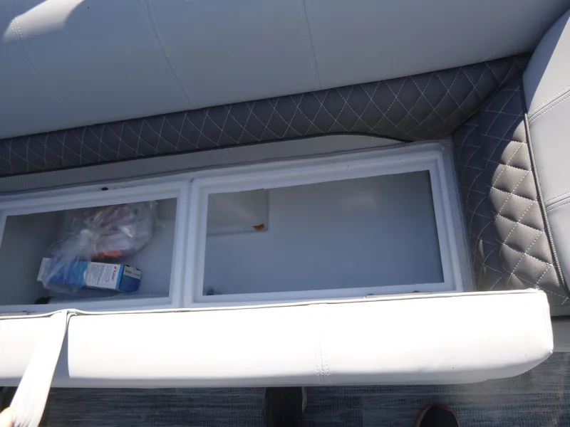 Slide: The Image of 2024 Ranger Reata 223C boat seat storage compartment with quilted upholstery. - 16