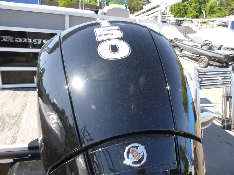 Slide: The Image of 2024 Ranger Reata 223C boat with a 50 HP outboard motor, docked outdoors. - 17