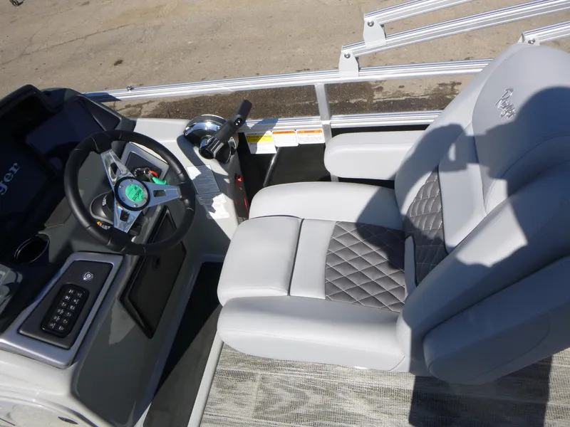 Slide: The Image of 2024 Ranger Reata 223C boat interior with steering wheel and luxurious seating. - 7