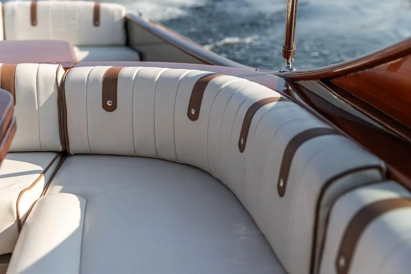 Slide: The Image of Luxurious seating on a 2003 Hinckley Talaria 29R boat with elegant leather details. - 19
