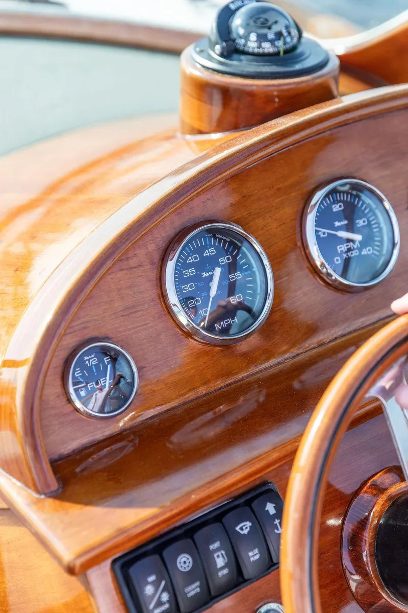 Slide: The Image of Wooden dashboard of 2003 Hinckley Talaria 29R boat with gauges and compass. - 30