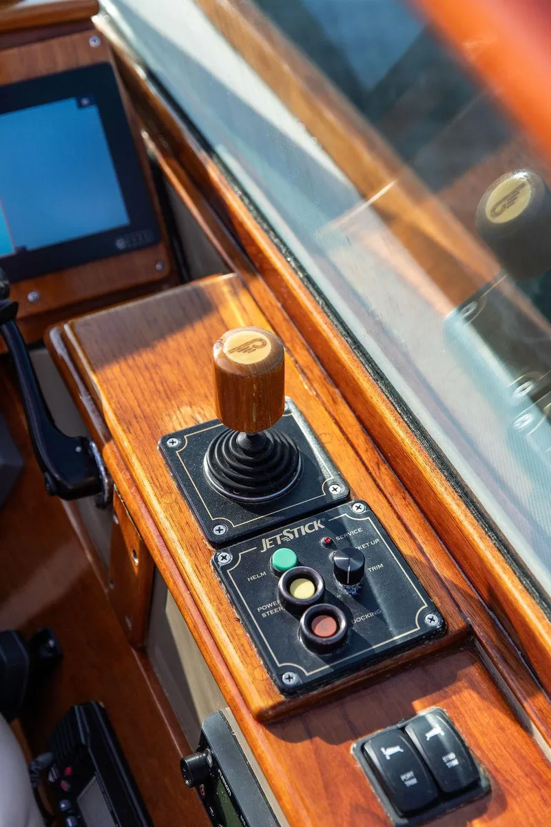 Slide: The Image of Hinckley Talaria 29R 2003 boat cockpit with joystick control and wooden dashboard. - 34