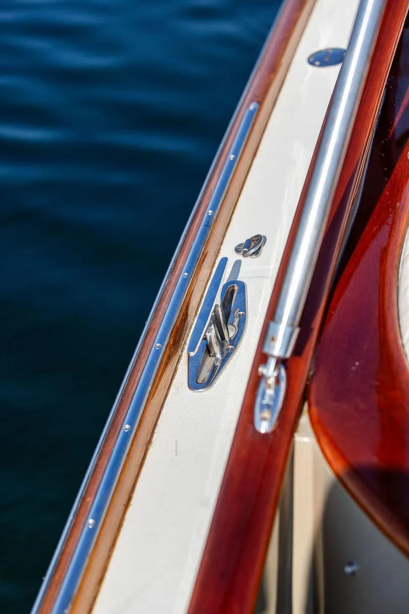 Slide: The Image of Close-up of 2003 Hinckley Talaria 29R boat railing and cleat on water. - 37