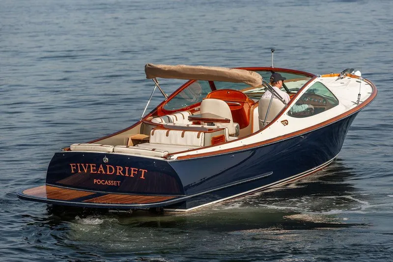 Slide: The Image of 2003 Hinckley Talaria 29R boat cruising on water, featuring elegant design and luxury seating. - 4