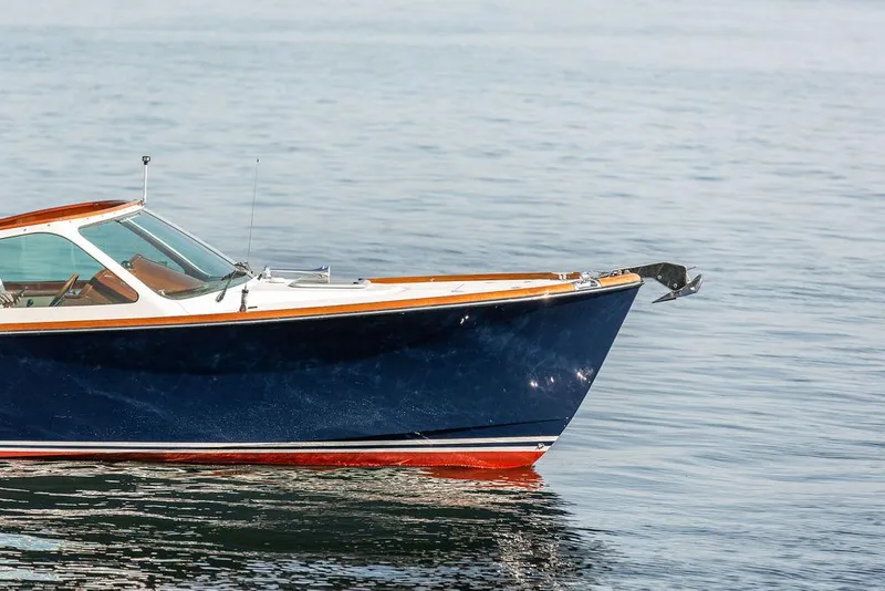 Slide: The Image of 2003 Hinckley Talaria 29R boat on calm water, showcasing sleek design and craftsmanship. - 9
