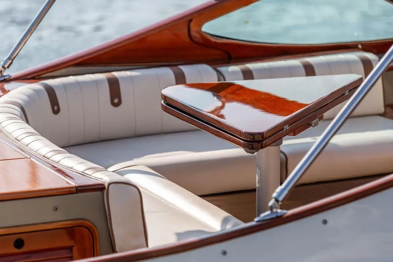 Slide: The Image of Luxurious interior of 2003 Hinckley Talaria 29R boat with polished wood table. - 22