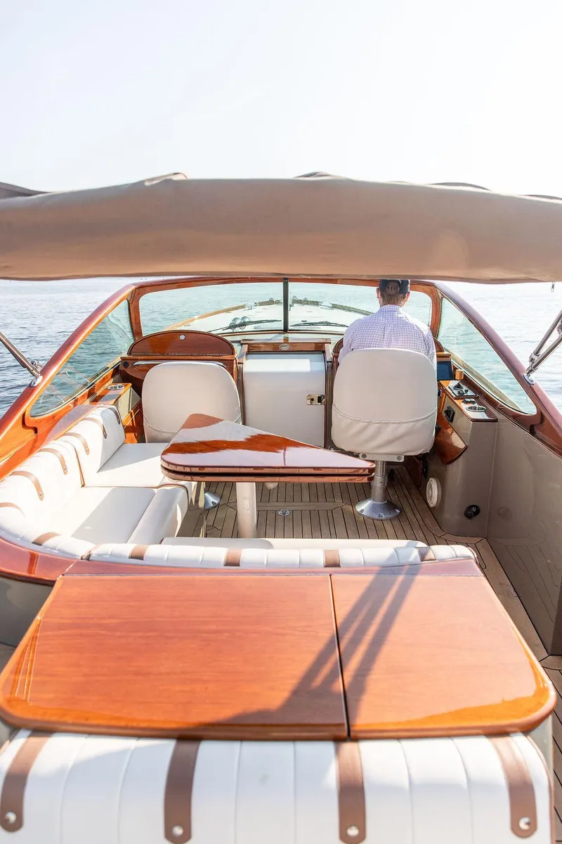 Slide: The Image of 2003 Hinckley Talaria 29R boat interior with elegant wood finish and seating. - 23