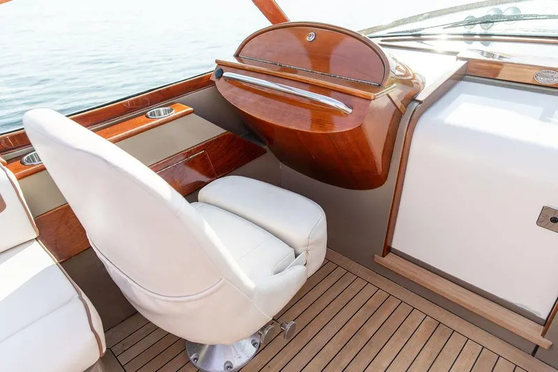 Slide: The Image of Luxurious interior of 2003 Hinckley Talaria 29R with white seating and wooden accents. - 24