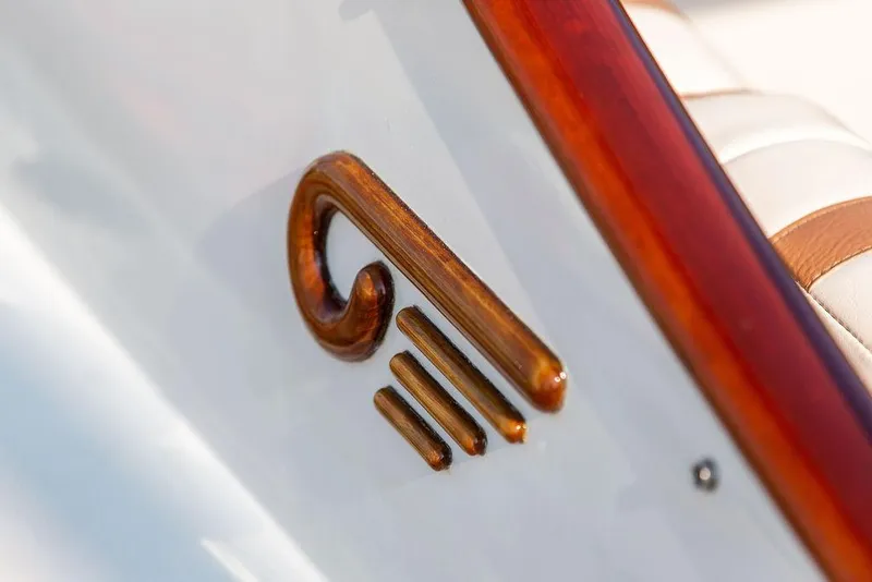 Slide: The Image of Close-up of a wooden emblem on a 2003 Hinckley Talaria 29R boat. - 40