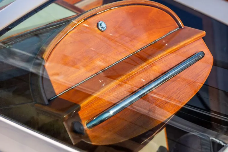 Slide: The Image of Wooden dashboard detail of a 2003 Hinckley Talaria 29R boat. - 44