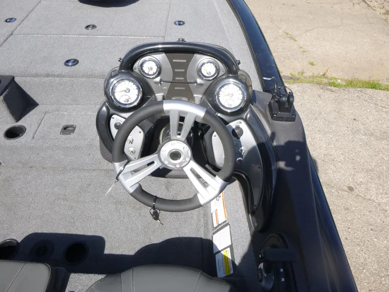 Slide: The Image of 2023 Tracker Pro Team 195 TXW Tournament Edition boat dashboard with steering wheel and gauges. - 7