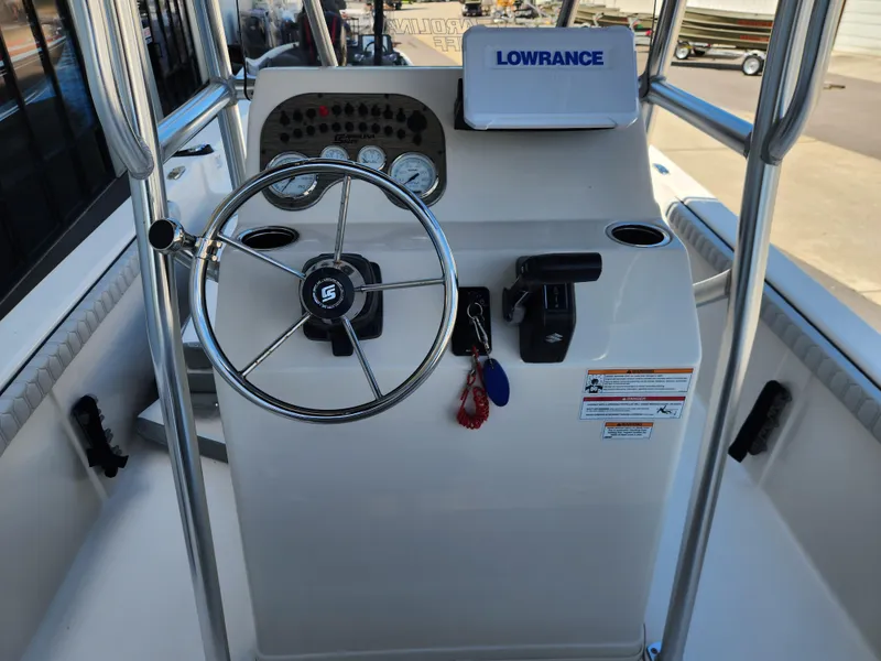 Slide: The Image of 2024 Carolina Skiff 23 LS boat console with steering wheel and Lowrance equipment. - 10
