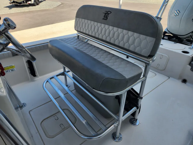 Slide: The Image of 2024 Carolina Skiff 23 LS boat seat with gray upholstery and metal frame. - 11