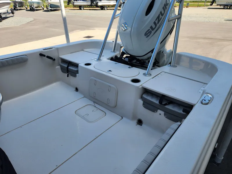 Slide: The Image of 2024 Carolina Skiff 23 LS boat interior with Suzuki outboard motor. - 13