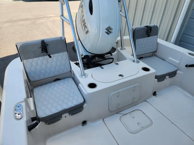 Slide: The Image of 2024 Carolina Skiff 23 LS boat interior with seating and Suzuki engine. - 14