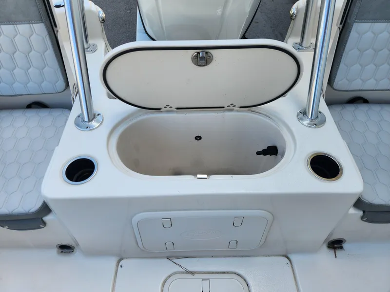 Slide: The Image of 2024 Carolina Skiff 23 LS boat interior with open storage compartment and cup holders. - 15