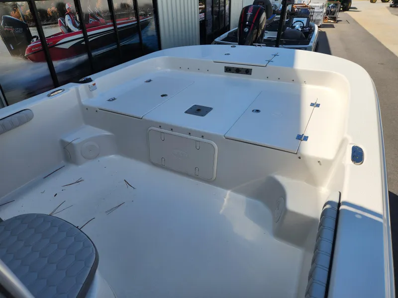 Slide: The Image of 2024 Carolina Skiff 23 LS boat interior with storage compartments and seating. - 6