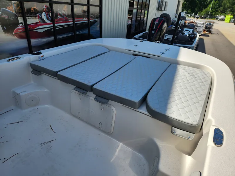 Slide: The Image of 2024 Carolina Skiff 23 LS boat interior with cushioned seating and storage compartments. - 7