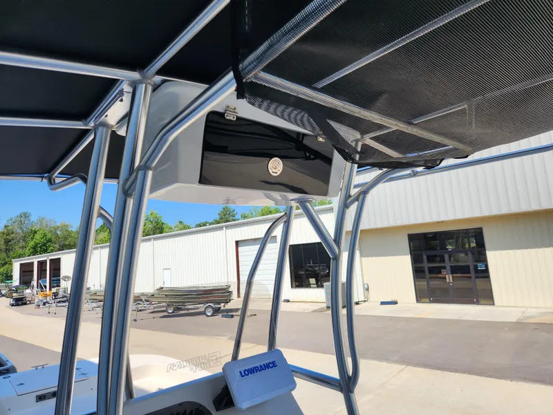 Slide: The Image of 2024 Carolina Skiff 23 LS boat with T-top and Lowrance equipment at a marina. - 9