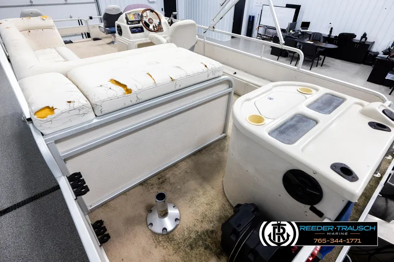 Slide: The Image of 2007 Premier 2223 Navigator boat interior with worn seating and control panel. - 11