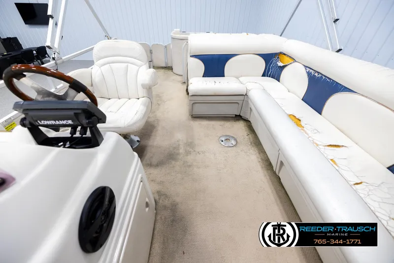 Slide: The Image of 2007 Premier 2223 Navigator boat interior with worn seating and steering wheel. - 14