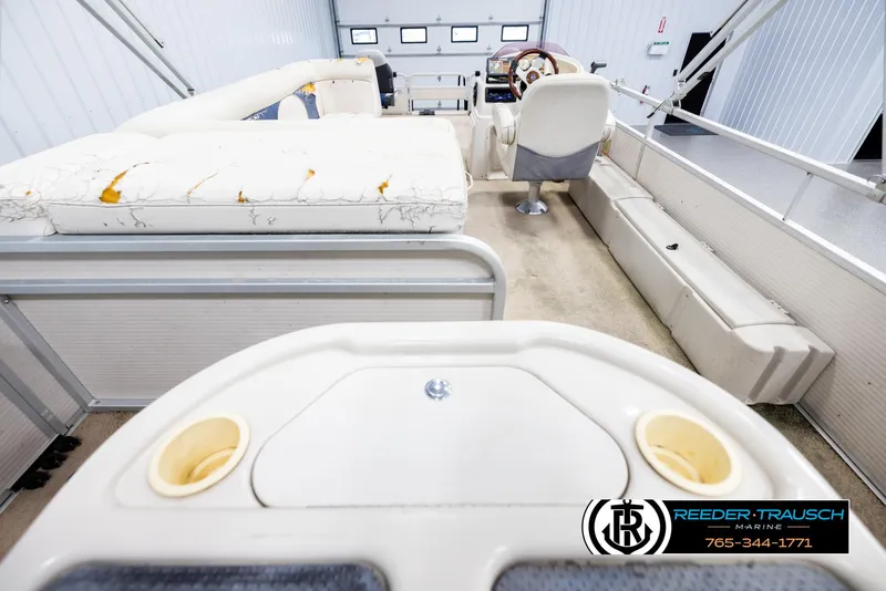 Slide: The Image of 2007 Premier 2223 Navigator boat interior with worn seating and steering console. - 16