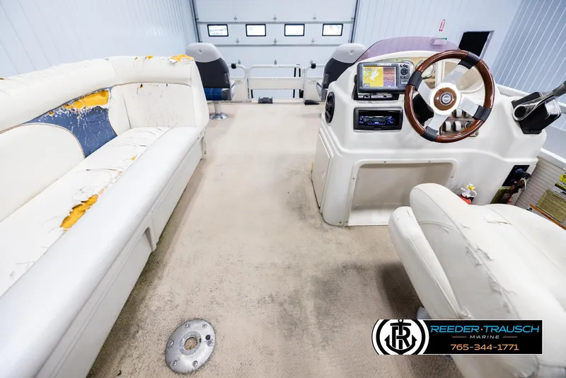 Slide: The Image of Interior of a 2007 Premier 2223 Navigator boat with worn seating and steering console. - 17
