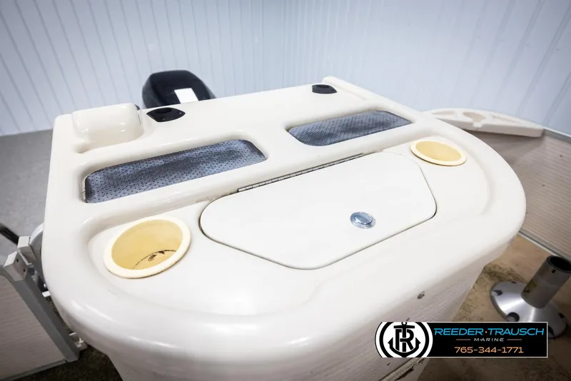 Slide: The Image of 2007 Premier 2223 Navigator boat console with cup holders and storage compartment. - 21