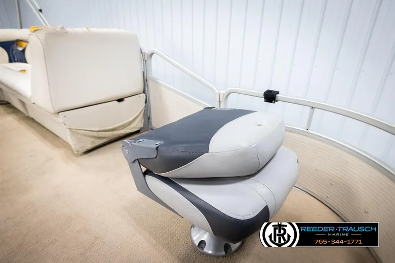 Slide: The Image of 2007 Premier 2223 Navigator boat seat with gray and white upholstery, Reeder-Trausch Marine logo. - 23