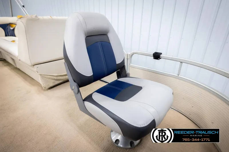 Slide: The Image of Premier 2223 Navigator 2007 boat seat, blue and gray upholstery, indoor setting. - 24