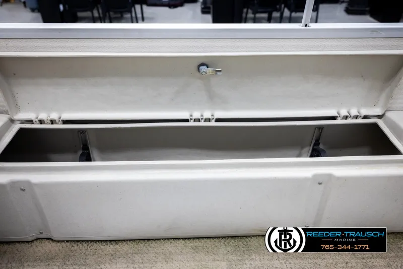 Slide: The Image of Open storage compartment of a 2007 Premier 2223 Navigator boat, displayed indoors. - 26