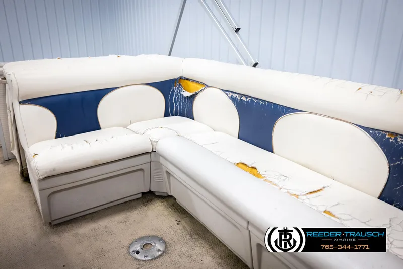 Slide: The Image of Worn seating on a 2007 Premier 2223 Navigator boat, showing significant upholstery damage. - 27