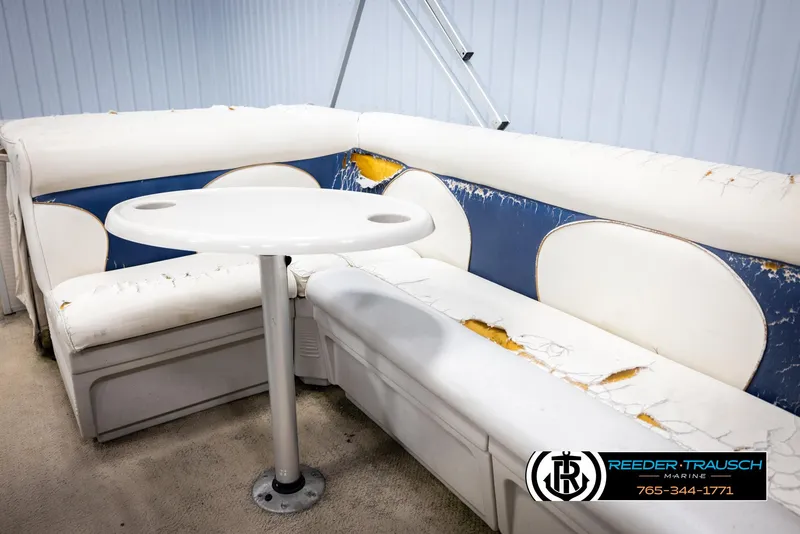 Slide: The Image of Worn seating area on 2007 Premier 2223 Navigator boat with table, showing visible damage. - 28