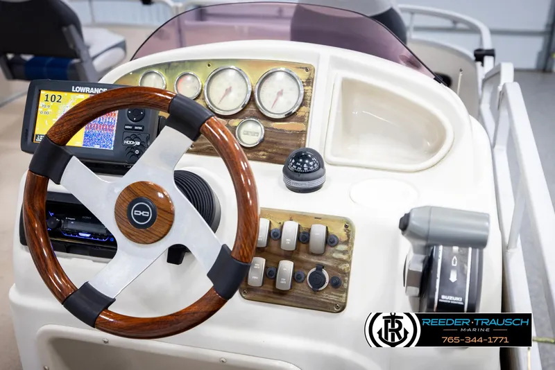 Slide: The Image of Steering console of a 2007 Premier 2223 Navigator boat with gauges and controls. - 29