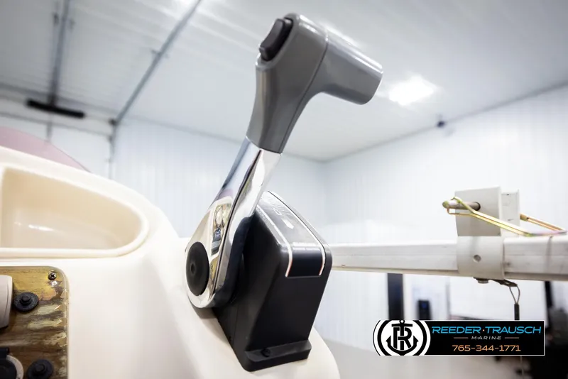 Slide: The Image of Close-up of a 2007 Premier 2223 Navigator boat throttle in a bright indoor setting. - 38