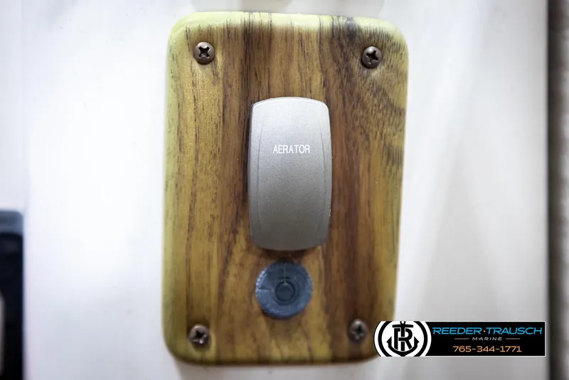 Slide: The Image of 2007 Premier 2223 Navigator aerator switch on wooden panel, Reeder-Trausch Marine logo visible. - 39