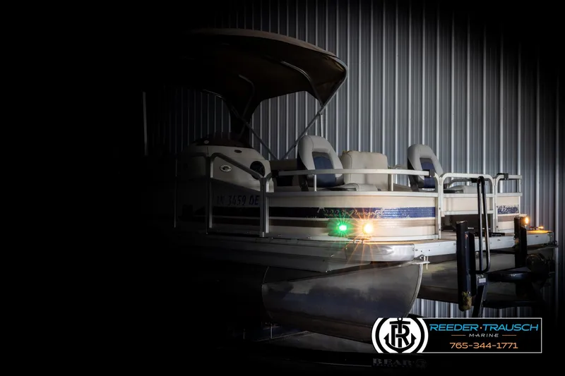 Slide: The Image of 2007 Premier 2223 Navigator pontoon boat in a dimly lit indoor setting. - 4
