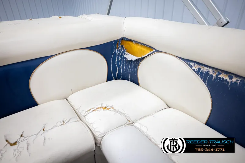 Slide: The Image of Damaged seating on 2007 Premier 2223 Navigator boat, showing torn upholstery and exposed foam. - 41