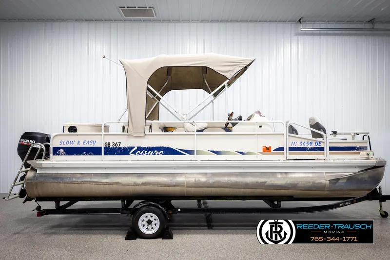 Slide: The Image of 2007 Premier 2223 Navigator pontoon boat with canopy, displayed indoors on a trailer. - 5