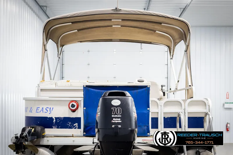 Slide: The Image of 2007 Premier 2223 Navigator boat with Suzuki 70 engine in a storage facility. - 7