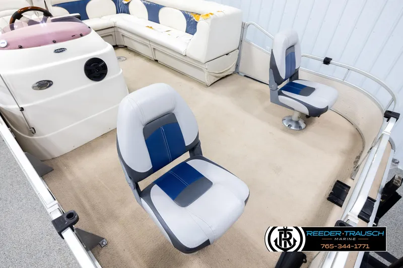 Slide: The Image of Interior of a 2007 Premier 2223 Navigator boat with seating and steering console. - 9